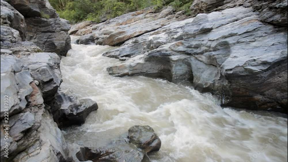 Mountain river running through the rocky canyon Mountain river running through the rocky canyon