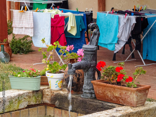 Water well and drying clothes in the courtyard of a Camino pilgrim hostel - Moratinos, Castile and Leon, Spain photo