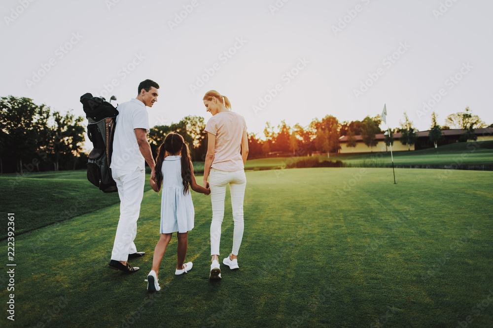 Happy Young Family Relax on Golf Field in Summer.