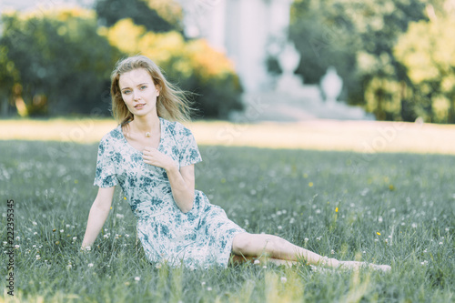 beautiful girl in the Park, in a summer dress and walking. Smiles and enjoys nature. St. Petersburg, Yelagin island photo