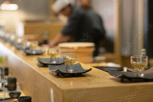 Lotus root appetizers on black ceramic dish, Omakase style Japanese traditional.