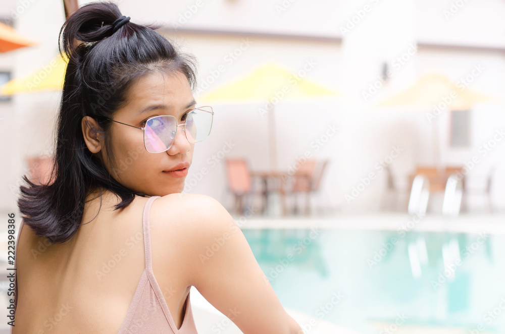 thai girl sitting on poolside bench thai girl sitting on poolside bench