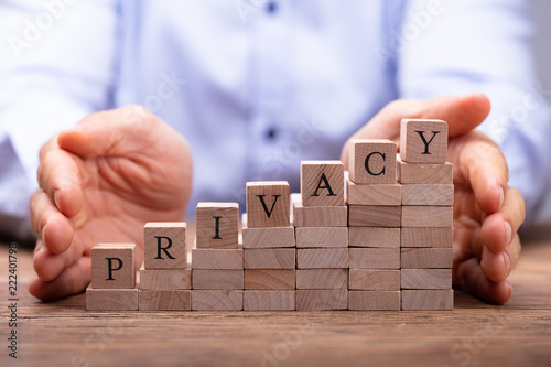 Fotografía Person's Hand Protecting Blocks With Privacy Text
