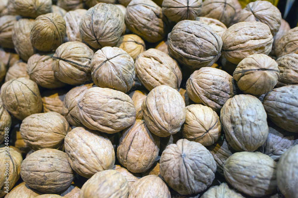 Walnut background, scattered pile of walnuts Walnut background, scattered pile of walnuts