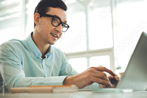 IT specialist. Professional smart man typing on the laptop while working as an IT specialist © zinkevych