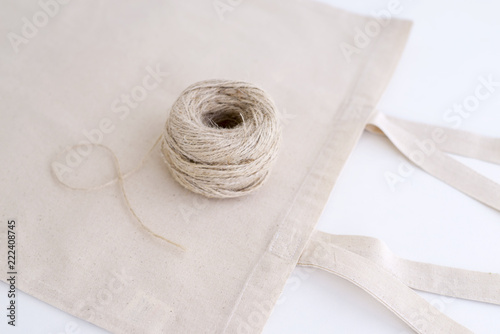 Cotton bag and coil of rope isolated on white