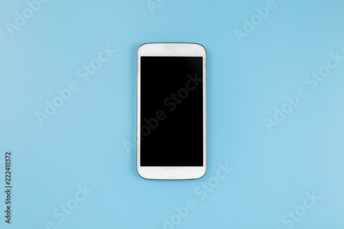 Mobile phone on blue background pastel style flatlay topview copyspace clipping path at screen
