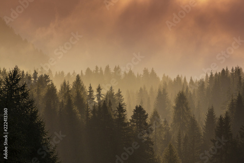 Dramatic rain clouds and thick mist at sunset, in the mountains, in summer