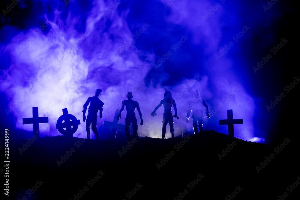Scary view of zombies at cemetery dead tree, moon, church and spooky cloudy sky with fog, Horror Halloween concept.