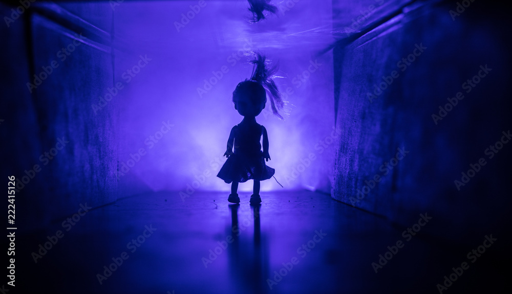 Fototapeta premium Creepy silhouette in the dark abandoned building. Horror about maniac concept or Dark corridor with cabinet doors and lights with silhouette of spooky horror person