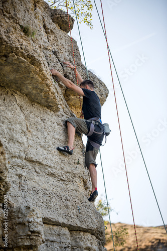 Photo of sports man climbing mountain