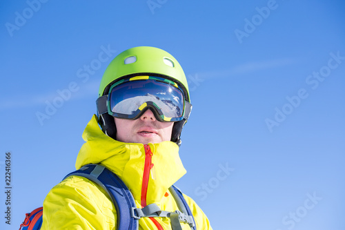 Photo of sporty man wearing mask and helmet against blue sky