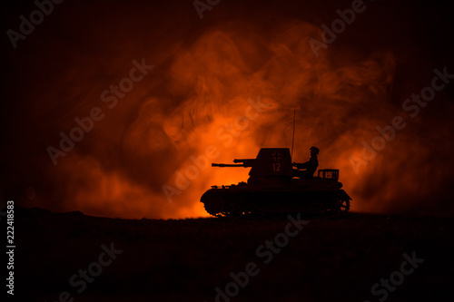 War Concept. Military silhouettes fighting scene on war fog sky background  World War German Tanks Silhouettes Below Cloudy Skyline At night. Attack scene. Armored vehicles.