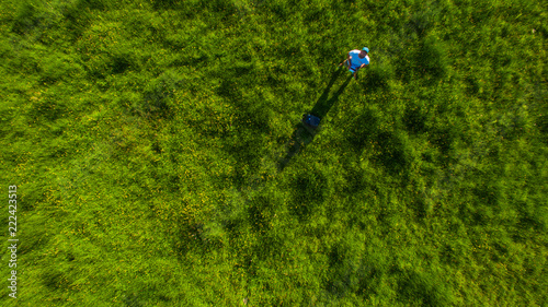 vertical drone shot of pilot in green grass