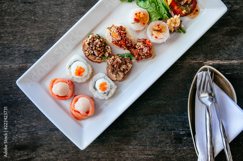Asian canapes appetizer - Smoked salmon, maki, larb, tuna tartare spring roll and grilled shrimps