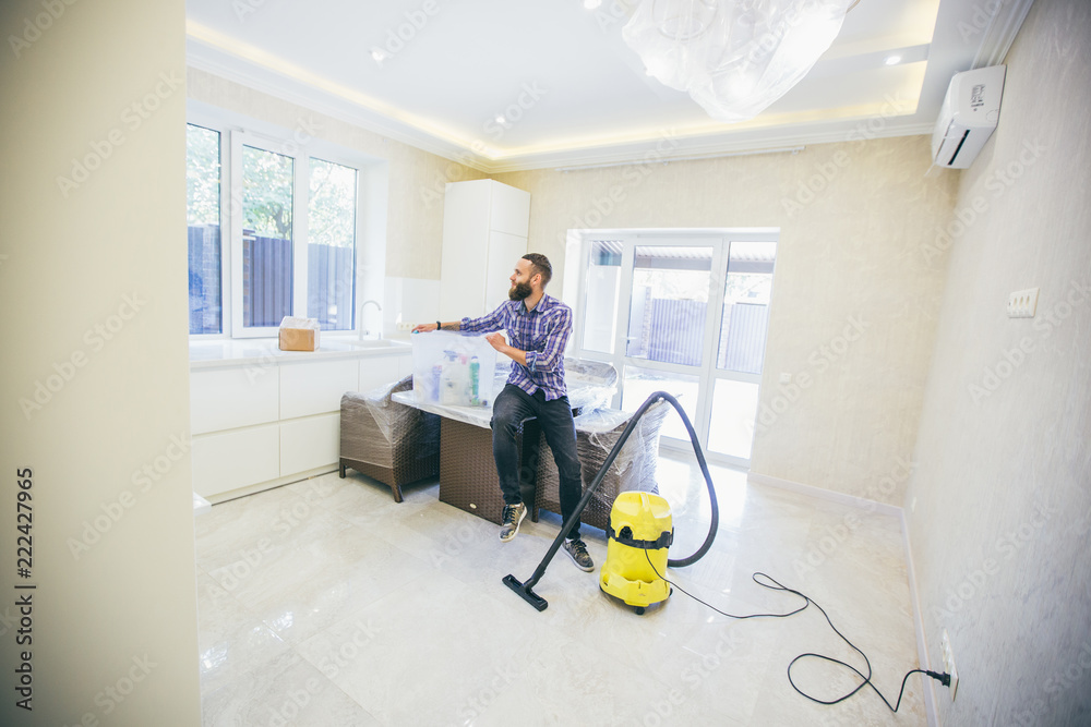 Young bearded man makes cleaning the house Young bearded man makes cleaning the house