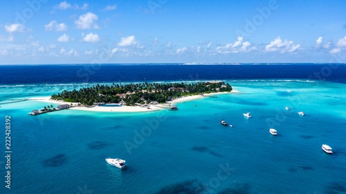 Aerial view of island white sand beach and blue lagoon in Maldives resort.