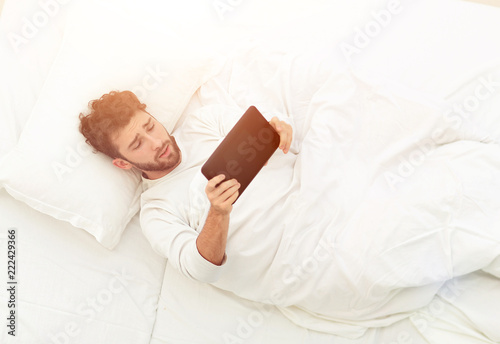 background image . man reading on digital tablet.