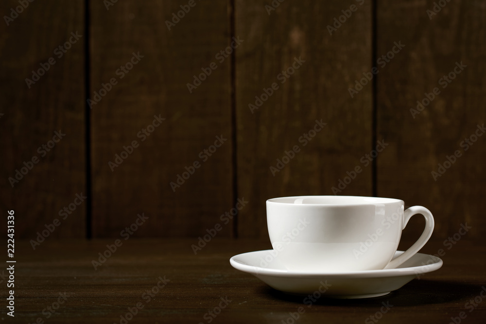one classic coffee or tea cup on a dark wooden background one classic coffee or tea cup on a dark wooden background