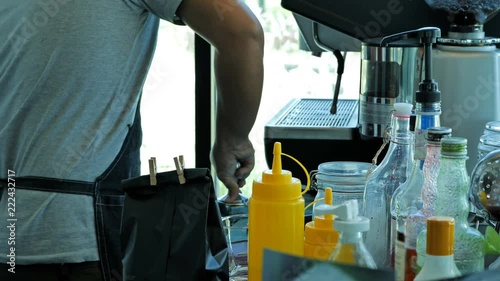 Professional barista prepares a latte with Tamping fresh coffee photo