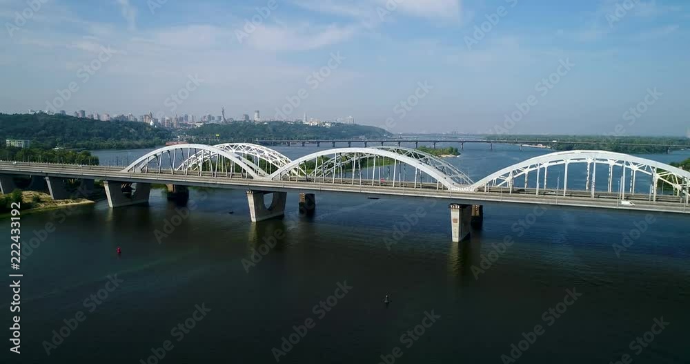 Aerial top view of automobile and railroad Darnitsky bridge across Dnieper river from above, Kiev city skyline Aerial top view of automobile and railroad Darnitsky bridge across Dnieper river from above, Kiev city skyline