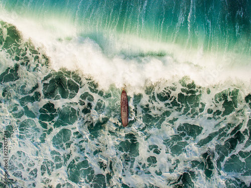 lonely breaking longboard aerial view surfergirl diving surf canggu indonesia photo