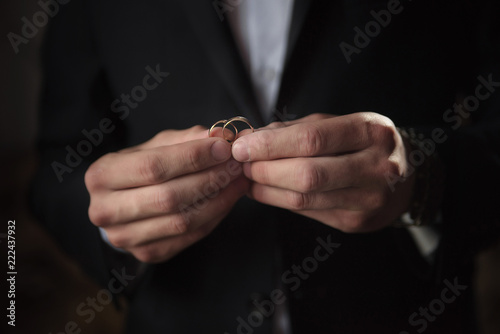 Wedding rings close-up in the hands of the groom.
