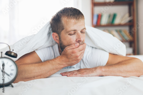Man finding it difficult to wake up in the morning