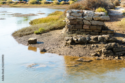 old pillar in the lagoon of ria formosa at low tide