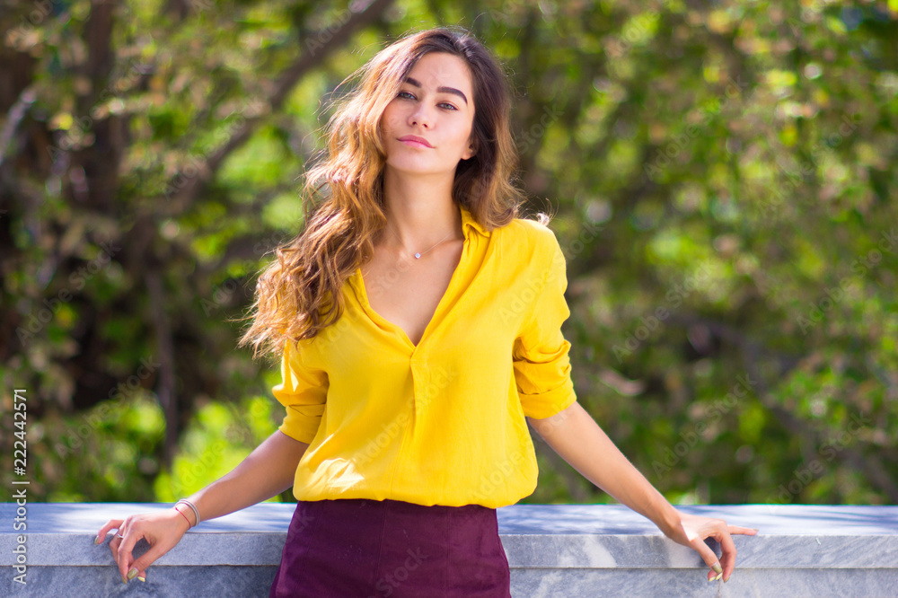 Portrait of a smiling girl in bright yellow clothes. Natural beauty concept. Portrait of a smiling girl in bright yellow clothes. Natural beauty concept.