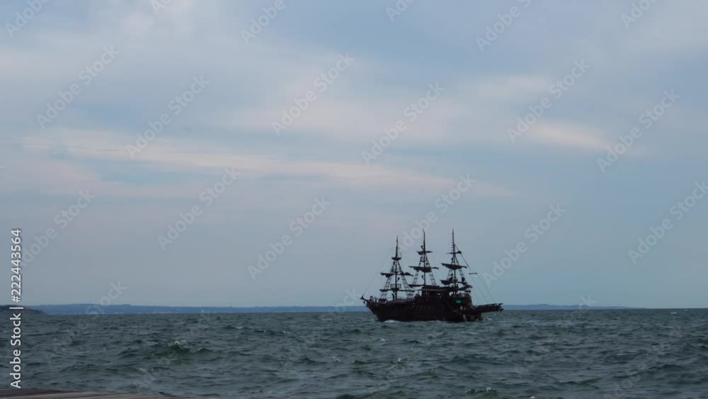 Stunning tourist attraction retro sail ship vessel sailing slowly in calm ocean waves in summer seascape skyline Stunning tourist attraction retro sail ship vessel sailing slowly in calm ocean waves in summer seascape skyline