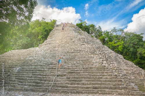 Young woman discovering the amazing Nohoch Mul Pyramid in Coba,Quintana Roo, Mexico photo