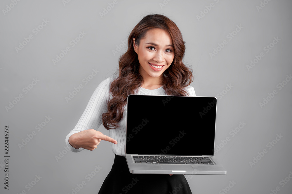 Happy business woman pointing on laptop blank screen Happy business woman pointing on laptop blank screen
