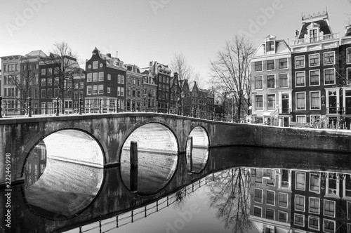 Beautiful sunrise view of the famous UNESCO world heritage canals of Amsterdam, the Netherlands, in black and white. Keizersgracht (Emperors canal)
