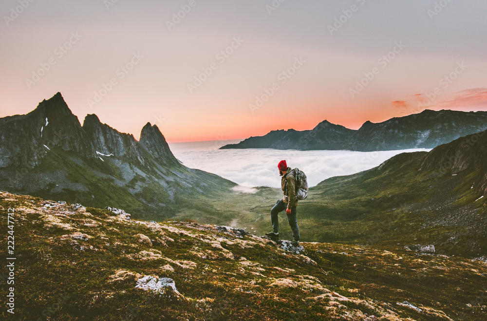 Man backpacker hiking in mountains alone  outdoor active lifestyle travel adventure vacations sunset Norway landscape - obrazy, fototapety, plakaty 