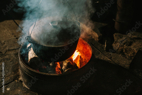 Making organic cheese in wooden mountain  Carpathian cheese factory with a boiling smoked cauldron with milk on open fire