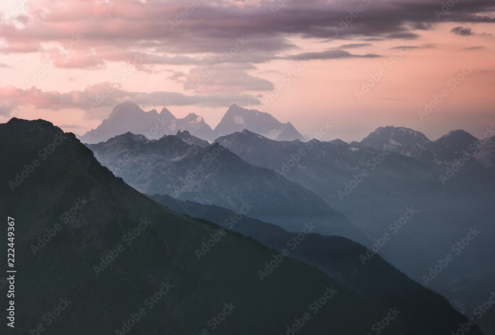 Sunset landscape rocky mountains peaks and clouds Landscape Travel locations wild nature scenic aerial view blue hour.