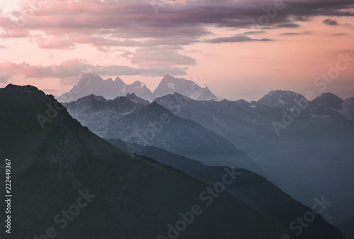 Fototapeta Naklejka Na Ścianę i Meble -  Sunset landscape rocky mountains peaks and clouds Landscape Travel locations wild nature scenic aerial view blue hour.