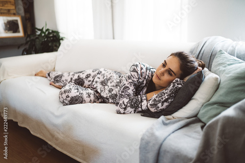 caucasian woman lying on sofa at home photo