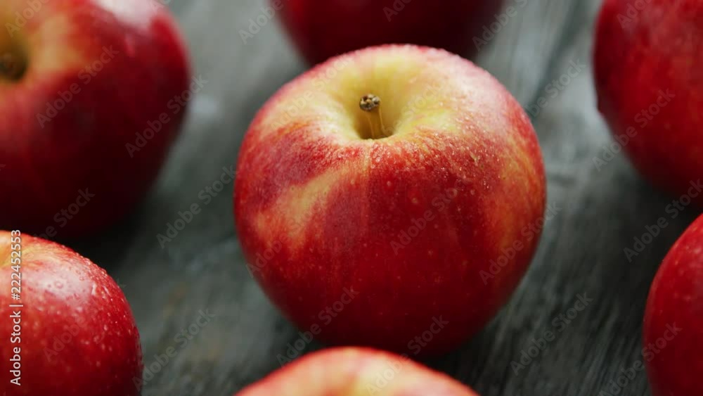 From above closeup shot of colorful red ripe apples on wooden background 