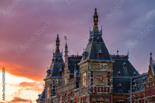 Beautiful view of the historic monument Amsterdam Central train station, at sunset