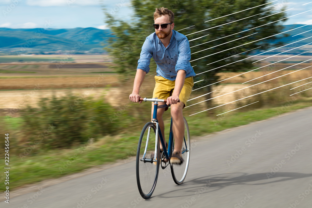 Naklejka premium Casual hipster cyclist riding bicycle with high speed concept