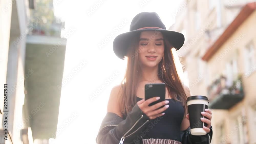 Beautiful young woman wearing white shirt and using modern smart phone, professional female employer typing text message on cellphone outside, slow motion Beautiful young woman wearing white shirt and using modern smart phone, professional female employer typing text message on cellphone outside, slow motion