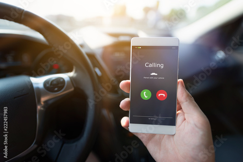 Man using phone calling system in car photo