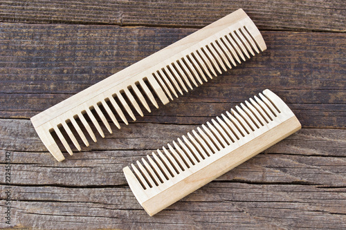 Combs on wooden background