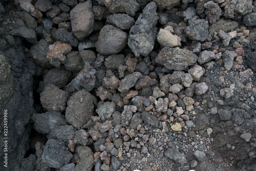 Texture of the dark land of the slopes of the mount Etna. An active volcano in Sicily Etna. People hike up this famous place to see this unusual landscape. Texture of the dark land of the slopes of the mount Etna. An active volcano in Sicily Etna. People hike up this famous place to see this unusual landscape.