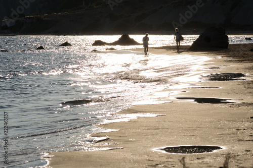 Sunset lights reflect on the shore of a nice sandy beach in Falconara, a little sea town near Butera in Sicily photo