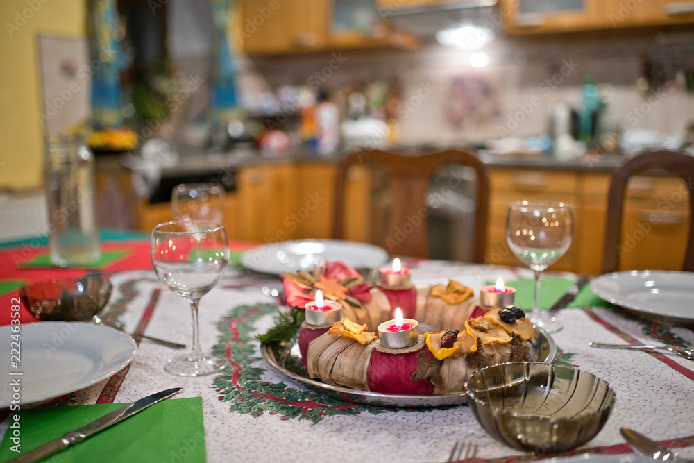 Advent wreath on the Christmas table in the Christmas eve.