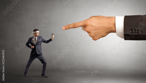 Small karate man fighting with big hand