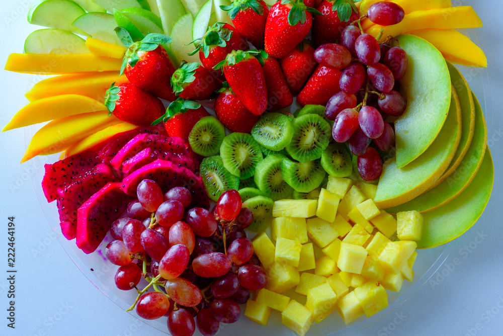 Fruit platter with fresh grapes, apple, pineapple, kiwi, mango, red ...